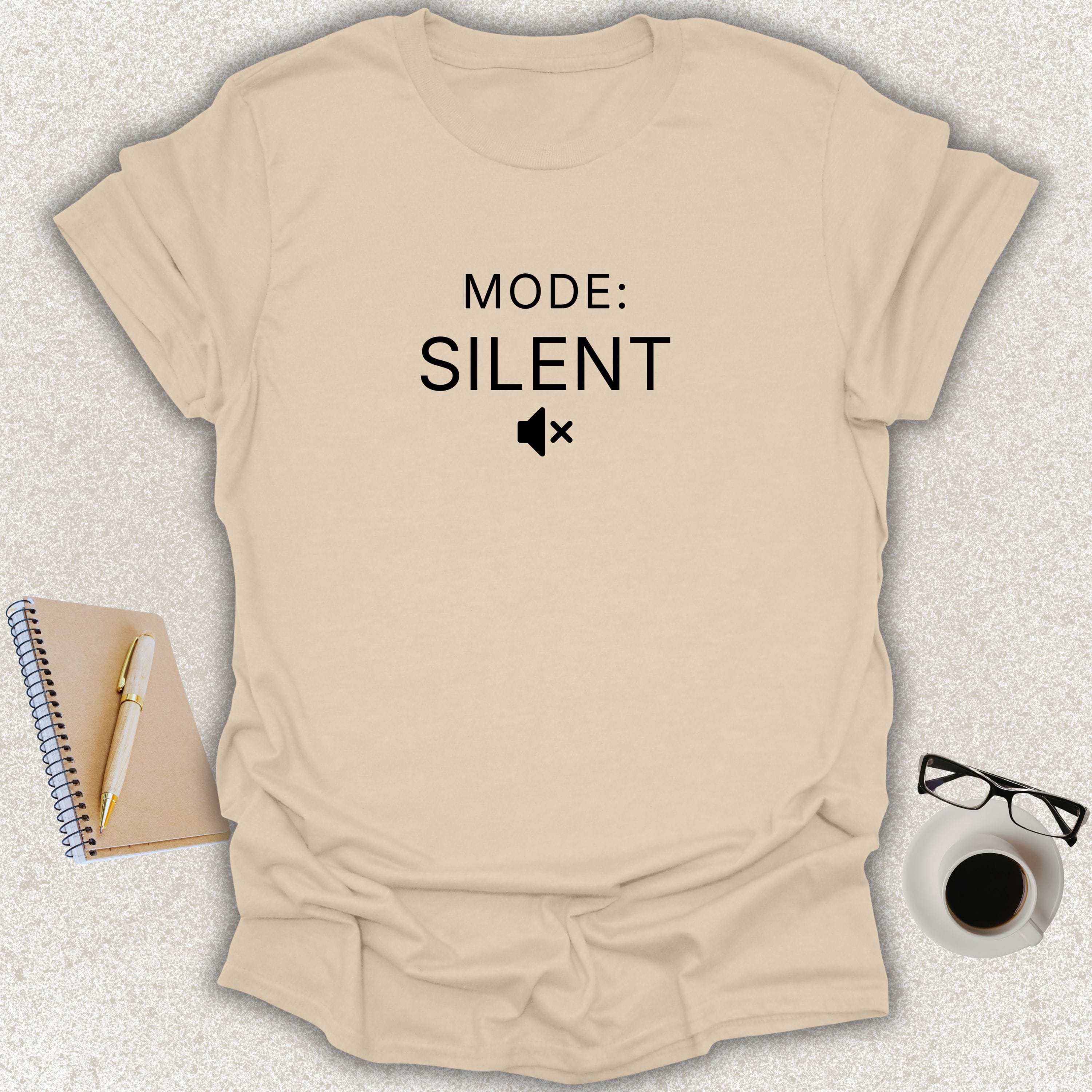 Low Signal MODE: SILENT minimalist typography t-shirt with muted speaker icon on sand Gildan Softstyle tee